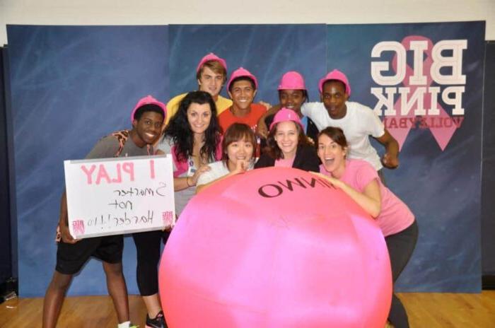 students with big pink ball and one student holding board 'I play smarter not harder!!'