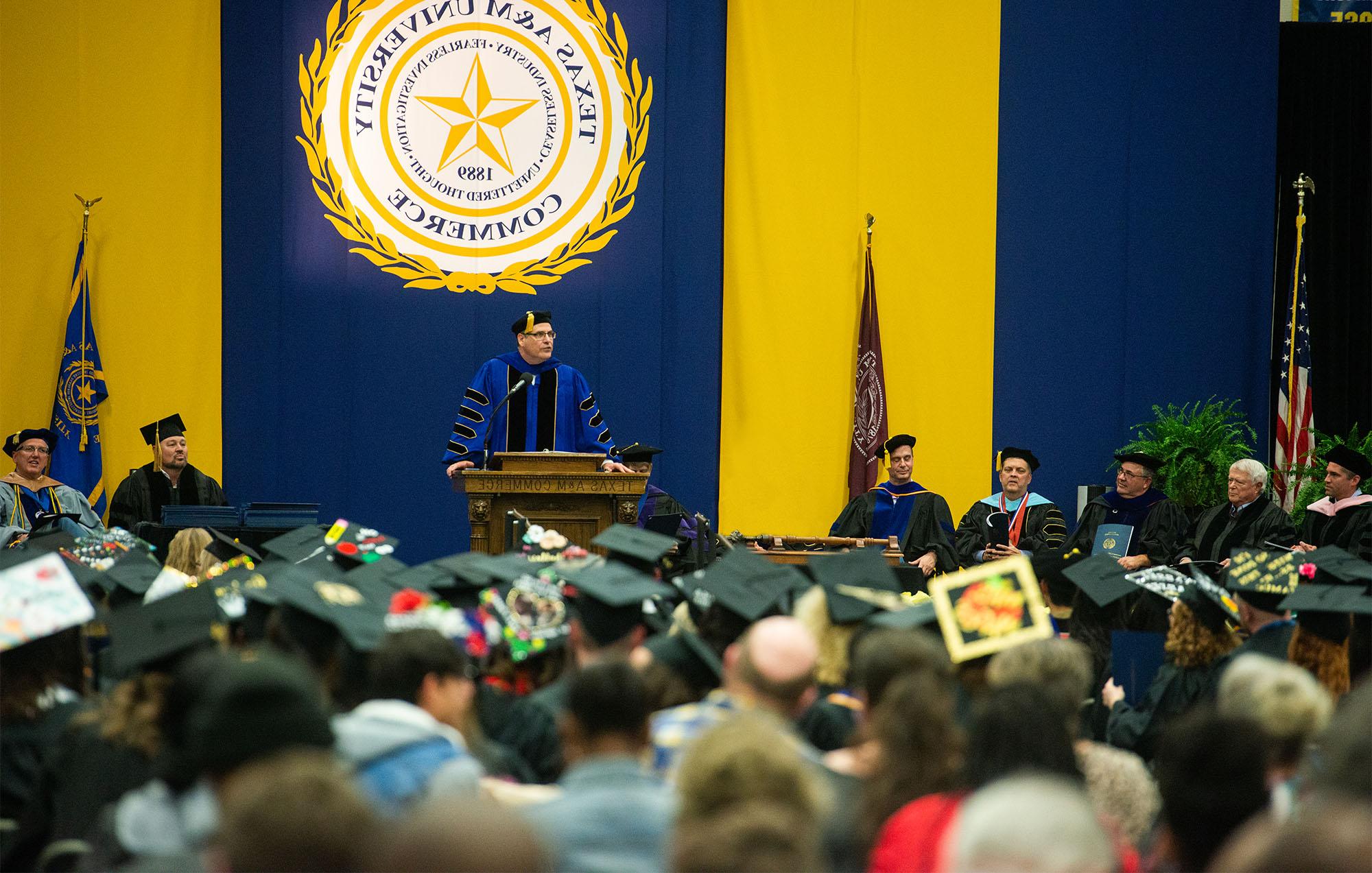 The president of the university making an announcement during graduation.