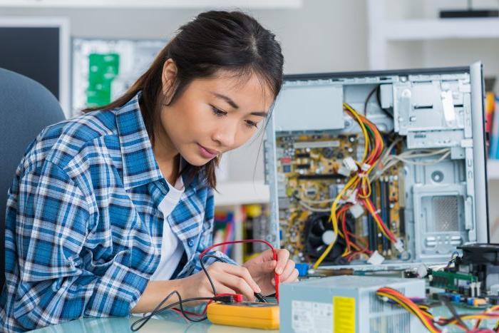 student girl in technology fixing computer hard drive